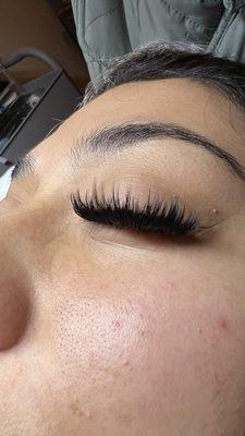 Mega volume wispy eyelash extensions. Full dark base with long textured lashes at the tips