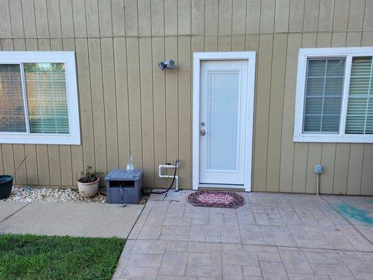 house rear. lower siding replaced and door replaced.