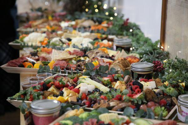 Grazing table charcuterie boards for a holiday event. Staging included greenery and mason jars for an elegant event.