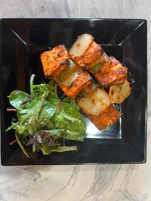 Paneer Tikka appetizer with a side of salad