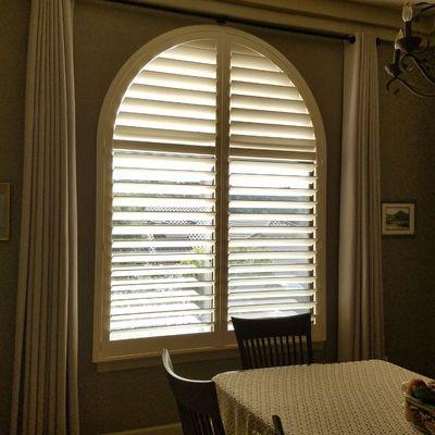 Custom drapery and Arched wood shutter