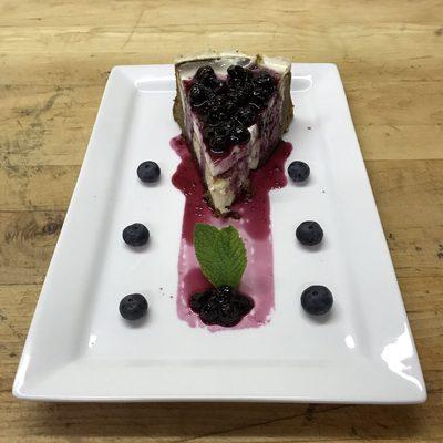 Decadent Cheesecake w/ Blueberry Red Wine Reduction.