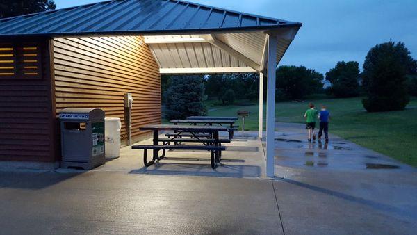 Pavilion with picnic tables, grill, trash, lights, and