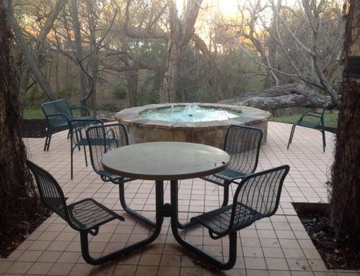 Gorgeous fountain with seating in the back of the facility.