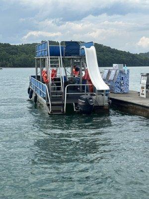 The Party Barge, a 30' foot pontoon with upper deck and slide.