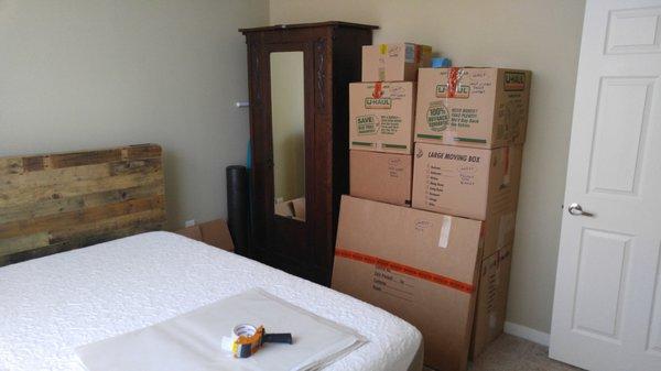 The bedroom boxes are packed, labeled and taped with a specific color to identify the room.