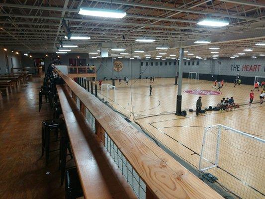 Upstairs seating area with view of all three courts