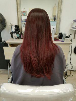 Deep red hair color with a smooth blow dry.