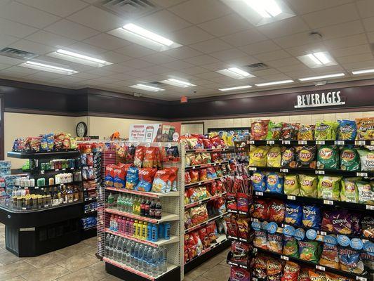 The usual convenience store snacks, drinks, alcohol, pantry goods, and travel items.