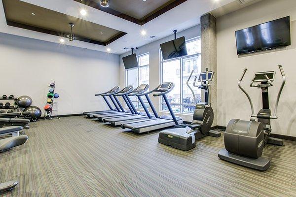 The fitness center includes Technogym equipment, cardio machines including a Peloton bike and more