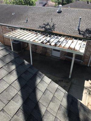 We are cleaning all the debris on top of the patio cover.