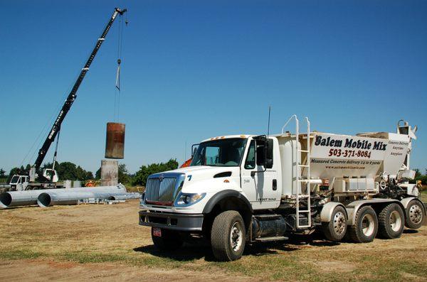 Pouring concrete at a cell tower.