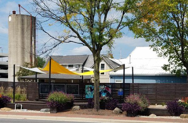 colorful plantings and tarp for shade