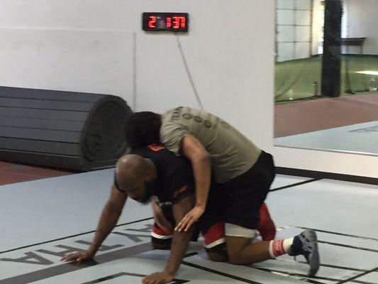 Pro fighter Luther Smith going over some wrestling drills with his oldest son Dante.