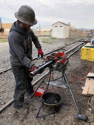 Repairing  steam pipe in the rail yard.