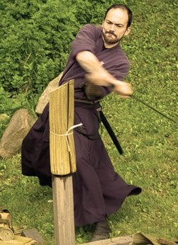 Chief Instructor of the Jinenkan Dojo in Mahopac, NY cutting tatmi mats while training in kenjutsu