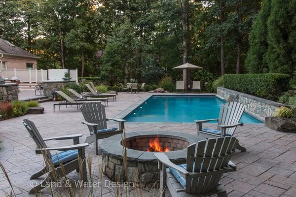 Enjoying an summer's evening by the pool and firepit