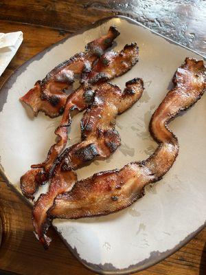 Bacon burnt on edges but raw in the center.