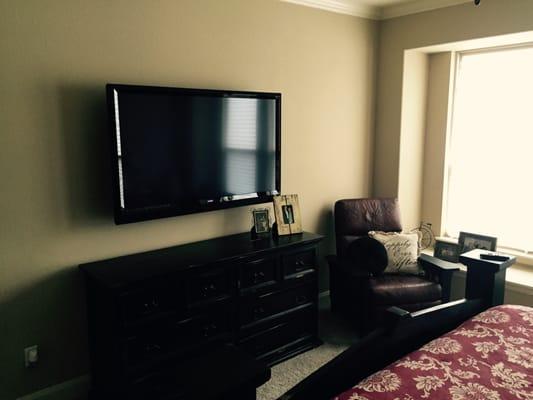 bedroom TV with cable box behind TV