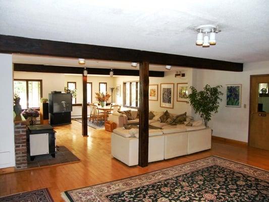 Home-like common area with big sreen TV and woodstove fireplace