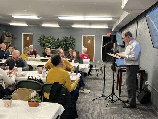 Fellowship hall.  Pastor Glenn addresses a breakfast meeting.