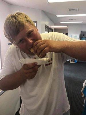 Justin is chowing down on a single chili cheese dog!