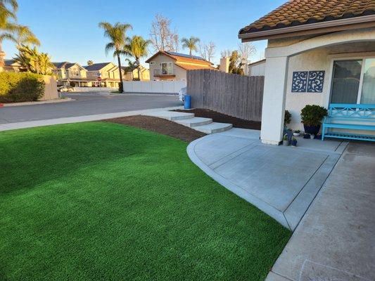 Artificial turf and concrete installed in our front yard to extend the patio and provide a large amount of play space for the kids