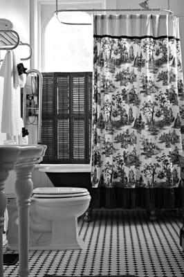 Brick House on Main's elegant, spacious bathroom, complete with vintage claw foot tub.