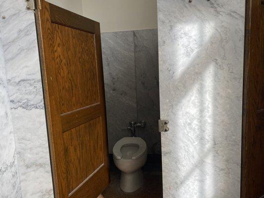 The most beautiful white marble, bar swinging door bathrooms in all of Michigan. located in the auditorium of fordson, Amazing history.