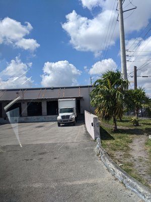 Cashier's office to purchase box/container/barrel and to pay for shipment after, walk up the steps to the right or the truck