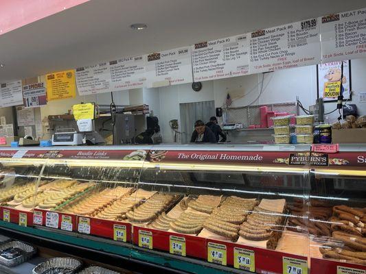 Meat counter with one employee working the front. Not good