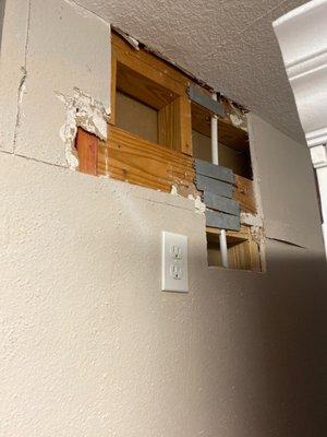 Another hole in wall where he rerouted unsuccessful plumbing job.