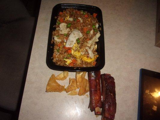 Here is my chicken fried rice, no fried chicken, boiled pieces dumped on top no seasoning . Included are my puffs and ribs burnt
 ing .