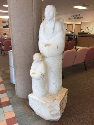 Alabaster statue of Hopi mom with her daughter and baby by front entrance...