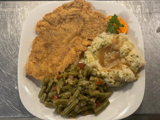 Fried pork chop mashed potato green beans either roll or cornbread. All meals come with two sides.