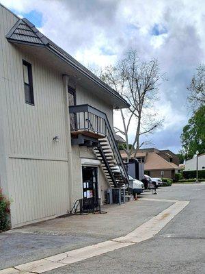 Entrance thru parking lot, behind First and C St