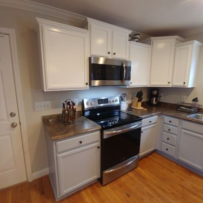 These cabinets were stained a medium cherry. The white and grey two tone really lighted up this kitchen.