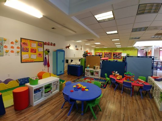 Our Toddler room serves ages 1 to 2 with a focus on areas for fine and large motor activities and teacher-led sensory and art projects.