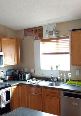 Before pic of water leak damage to kitchen wall.