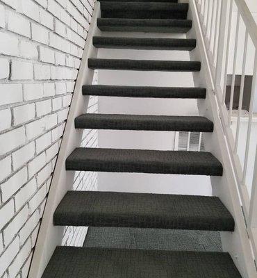 Wrap around staircase with nice pattern carpet