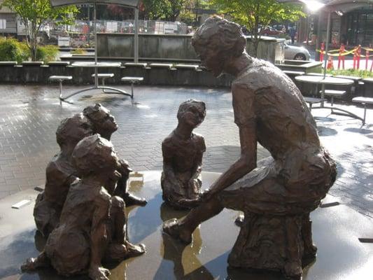 In this sculpture in front of the library, the mentor or mother looks more stern than nurturing, as in, "Why are you kids so dense?"