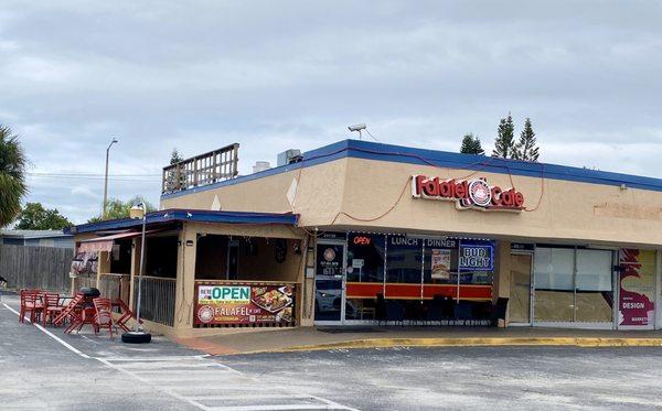 Exterior of Cafe with covered outdoor seating on the left.