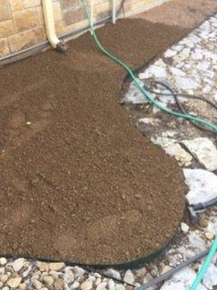 Installation of crushed granite around entire walkway of a house