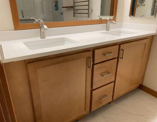 White Quartz countertop and backsplash. The heated towel bar is terrific!