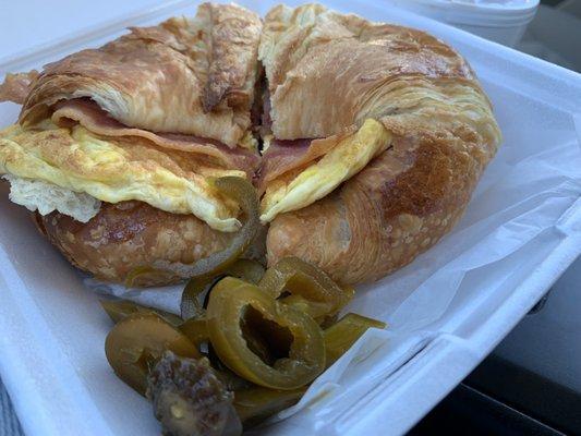 Ham Bacon and egg croissant with a side of jalapeños