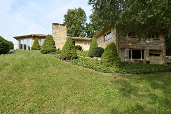 Sold!  This Frank Lloyd Wright style home was truly a "work of art" complete with murals and hand-carved doors...