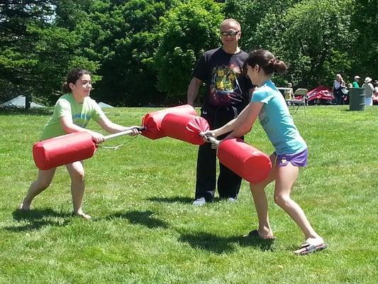 Grand Master Bobby at Opening Day of Greeley Park teaching two young girls reaction and reflex moves using double sided bonkers.