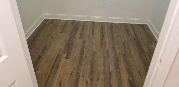 Vinyl wood plank flooring, trim work and painting