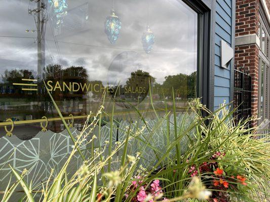 Front window with decal and flower box.