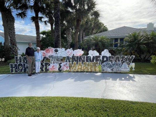 Son surprised parents with a yard card sign to celebrate their 70th anniversary.